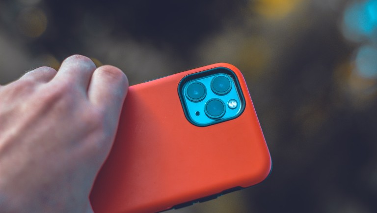 An iPhone with a red cover case