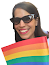 A woman with sunglasses holding the lgbt flaq