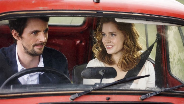 Man and woman in a red car