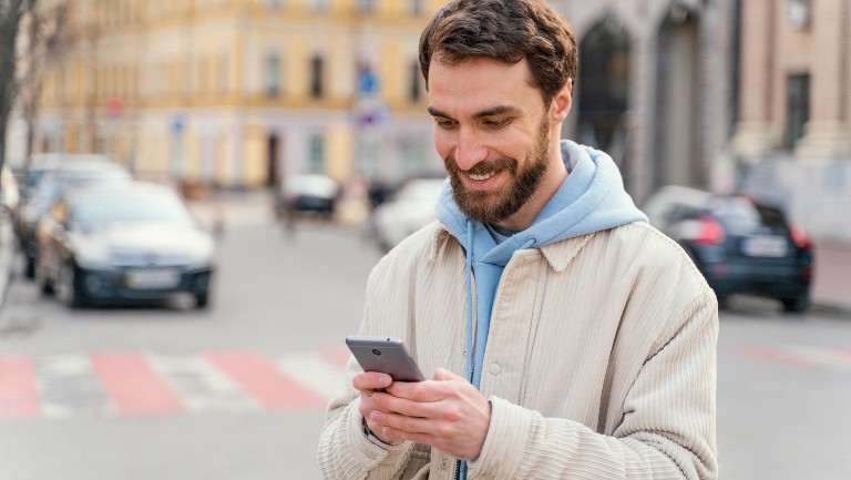 Man holding a mobile smiling
