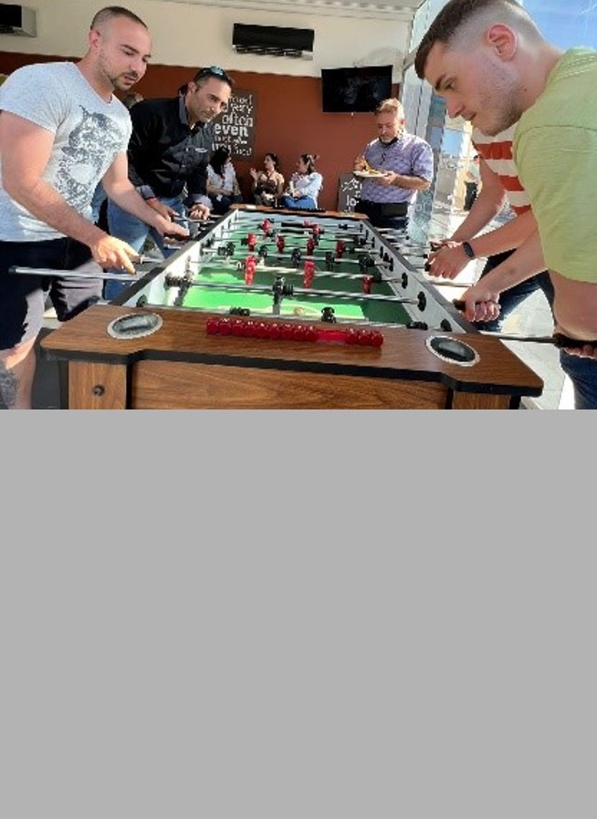Group of guys playing soccer table